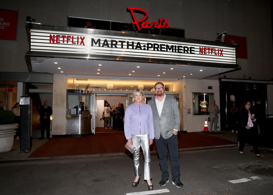 Martha Stewart, left and director R.J. Cutler at the NYC premiere of Martha, standing under the Paris theater marquee.