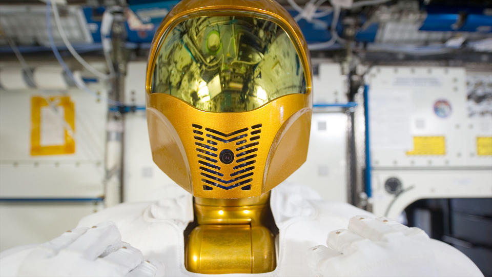 closeup of the gold helmet of a humanoid robot