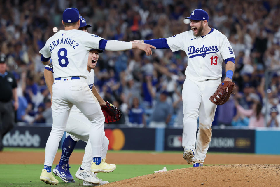 LOS ANGELES, CALIFORNIA - OCTOBER 20: Max Muncy #13 of the Los Angeles Dodgers celebrates with Enrique Hernández #8 and Tommy Edman #25 after defeating the New York Mets 10-5 in game six of the National League Championship Series to move onto the World Series at Dodger Field on Sunday, Oct. 20, 2024 in Los Angeles.(Robert Gauthier / Los Angeles Times via Getty Images)