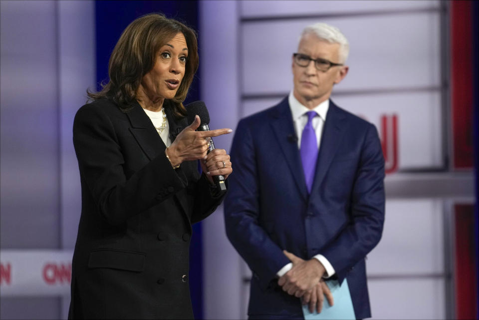 Democratic presidential nominee Vice President Kamala Harris speaks during a CNN town hall in Aston, Pa., Wednesday, Oct. 23, 2024, as moderator Anderson Cooper listens. (AP Photo/Matt Rourke)