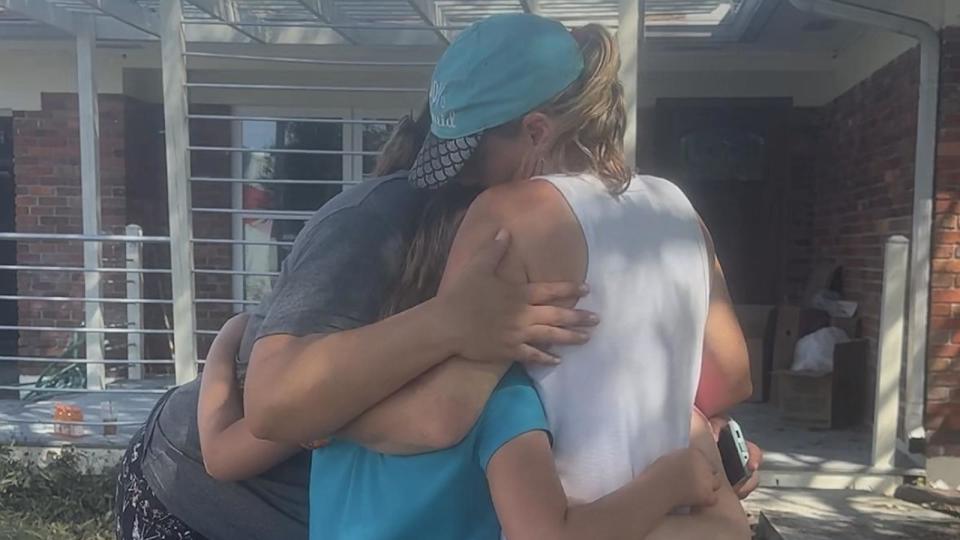 PHOTO: Sarah Spicer and her daughter Blakely hug neighbors after Hurricane Helene flooded parts of their neighborhood. (Sarah Spicer)