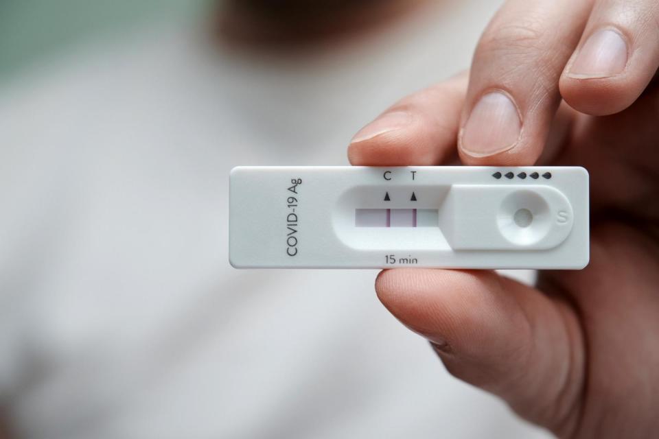 PHOTO: Close-up of a hand holding a positive antigen test for COVID-19. SARS-CoV-2 antigen rapid test kit. (STOCK IMAGE/Getty Images)