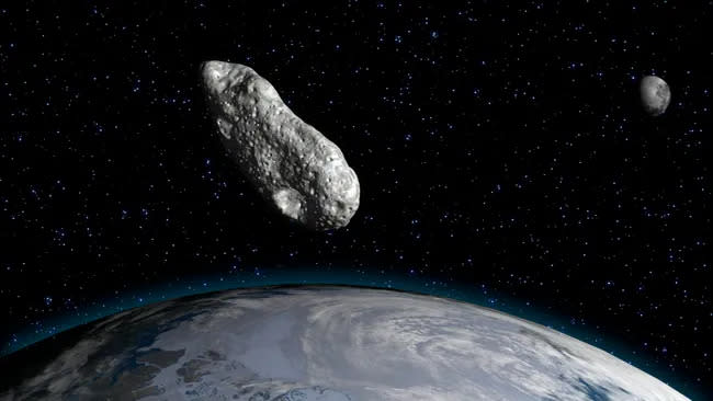  An illustration of an asteroid above Earth. 