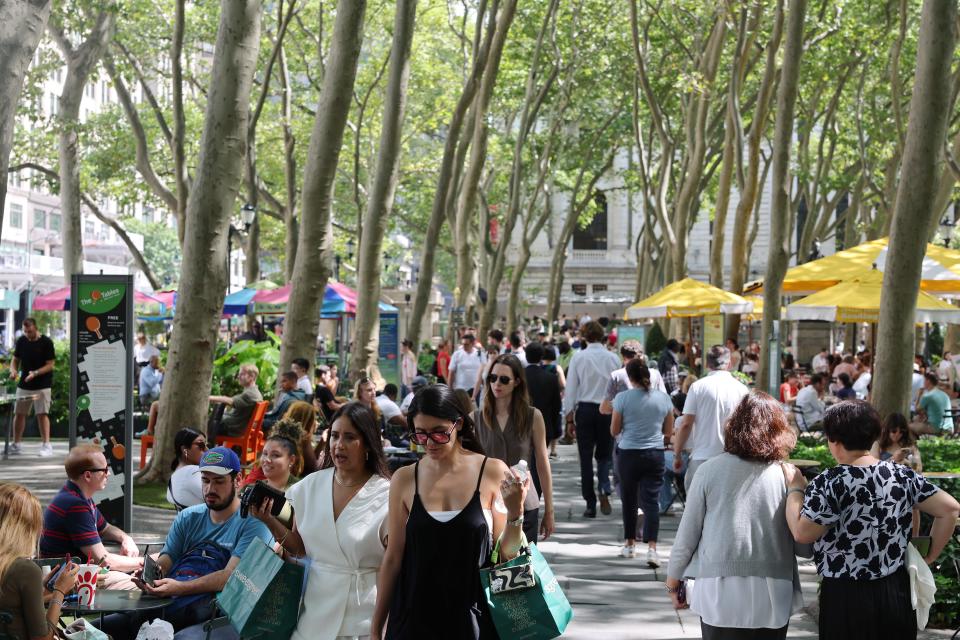 People sit in the shade in Bryant Park amid hot and humid temperatures on August 28, 2024 in New York City.