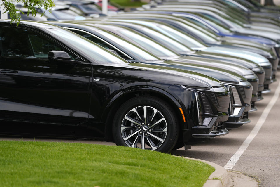 Unsold 2024 electric Lyriq utility vehicles sit in a row outside a Cadillac dealership Sunday, June 2, 2024, in Lone Tree, Colo. (AP Photo/David Zalubowski)