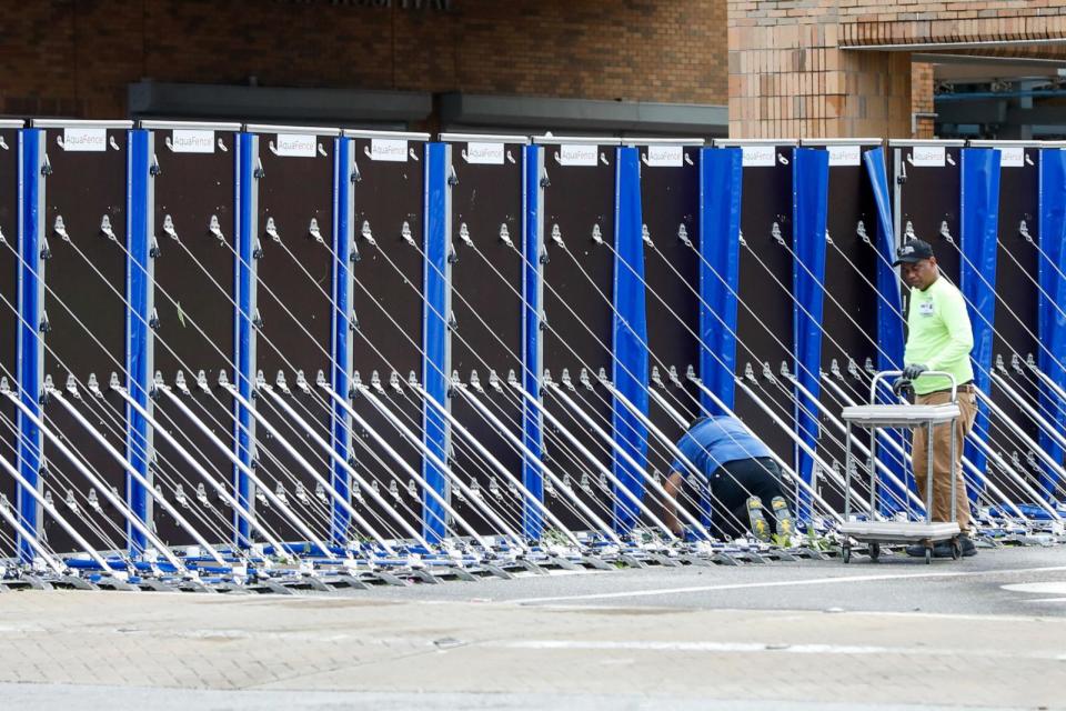 PHOTO: Workers take down an aqua fence at Tampa General Hospital on Oct. 10, 2024, in Tampa, Fla. (Jefferee Woo/Tampa Bay Times via ZUMA Press Wire via Newscom)