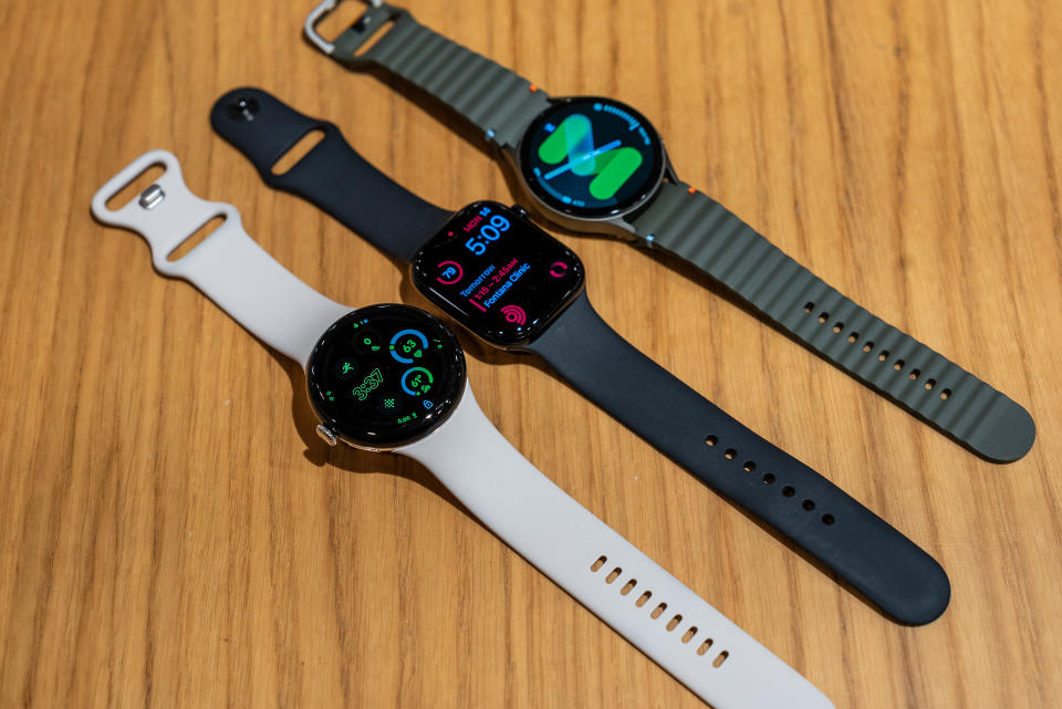 The Pixel Watch 3, Apple Watch Series 10, and Galaxy Watch 7 lying next to each other.