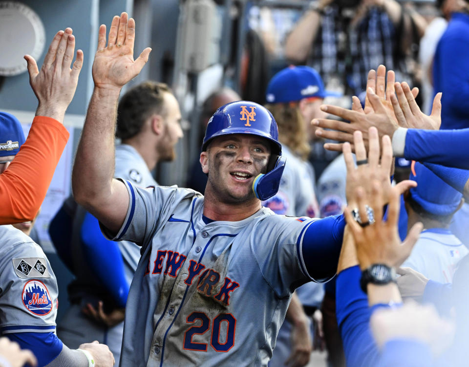 Los Angeles, CA - October 14:  Pete Alonso #20 of the New York Mets high fives teammates after scoring on a RBI double by teammate Starling Marte (not pictured) of the New York Mets against the Los Angeles Dodgers in the ninth inning of game 2 of a National League Championship Series playoff baseball game at Dodger Stadium in Los Angeles on Monday, October 14, 2024. (Photo by Keith Birmingham/MediaNews Group/Pasadena Star-News via Getty Images)