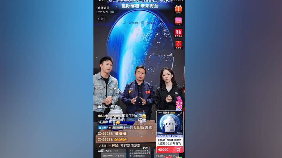 Deep Blue Aerospace CEO Huo Liang (center) sells two tickets for his company's 2027 spaceflight alongside two hosts during a livestream on commerce platform Taobao. - Taobao