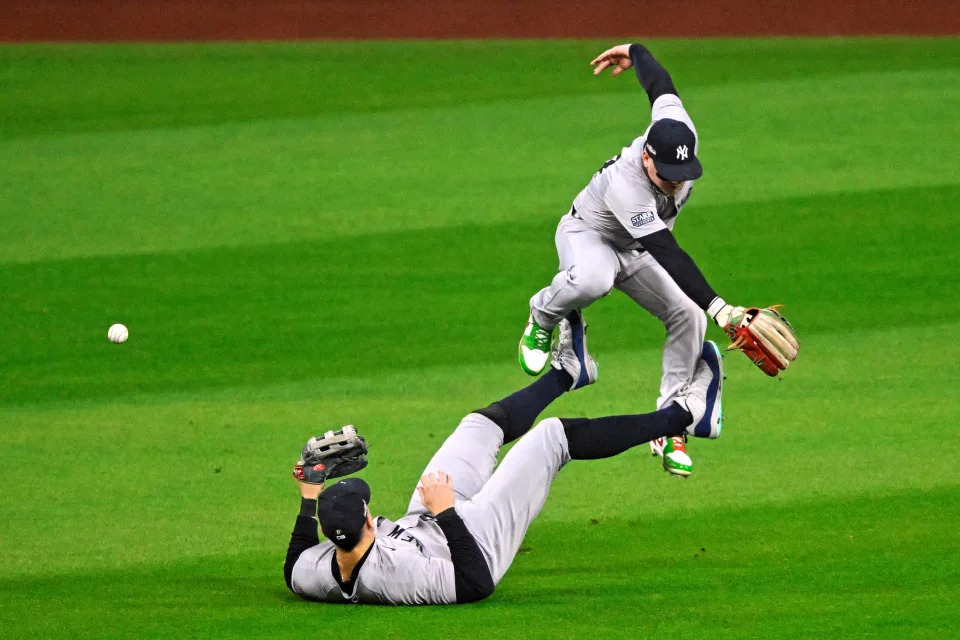 Oct 19, 2024; Cleveland, Ohio, USA; Oct 19, 2024; Cleveland, Ohio, USA; New York Yankees outfielder Aaron Judge (99) dives to a ball but can not make the catch as outfielder Alex Verdugo (24) has to jump over him during the fifth inning against the Cleveland Guardians during game five of the ALCS for the 2024 MLB playoffs at Progressive Field. Mandatory Credit: David Richard-Imagn Images     TPX IMAGES OF THE DAY