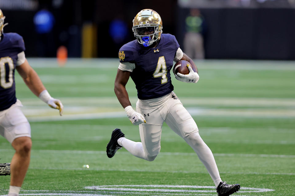 ATLANTA, GA - OCTOBER 19: Notre Dame Fighting Irish running back Jeremiyah Love (4) carries the ball during the college football game between the Georgia Tech Yellow Jackets and the Notre Dame Fighting Irish on October 19, 2024 at the Mercedes-Benz Stadium in Atlanta, Georgia.  (Photo by David J. Griffin/Icon Sportswire via Getty Images)