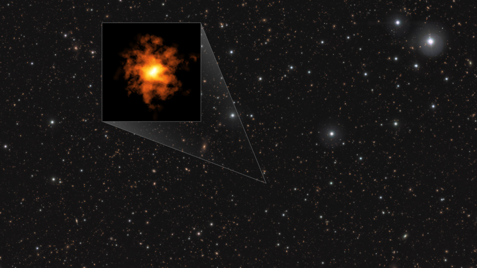  A large field of stars with a highlighted black box containing a glowing orange irregularly shaped blob. 