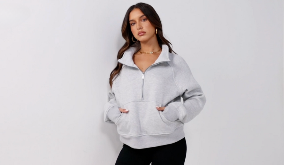 woman wearing heather gray half zip sweatshirt