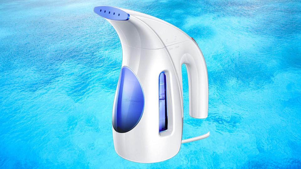 Blue and white travel steamer over blue background.