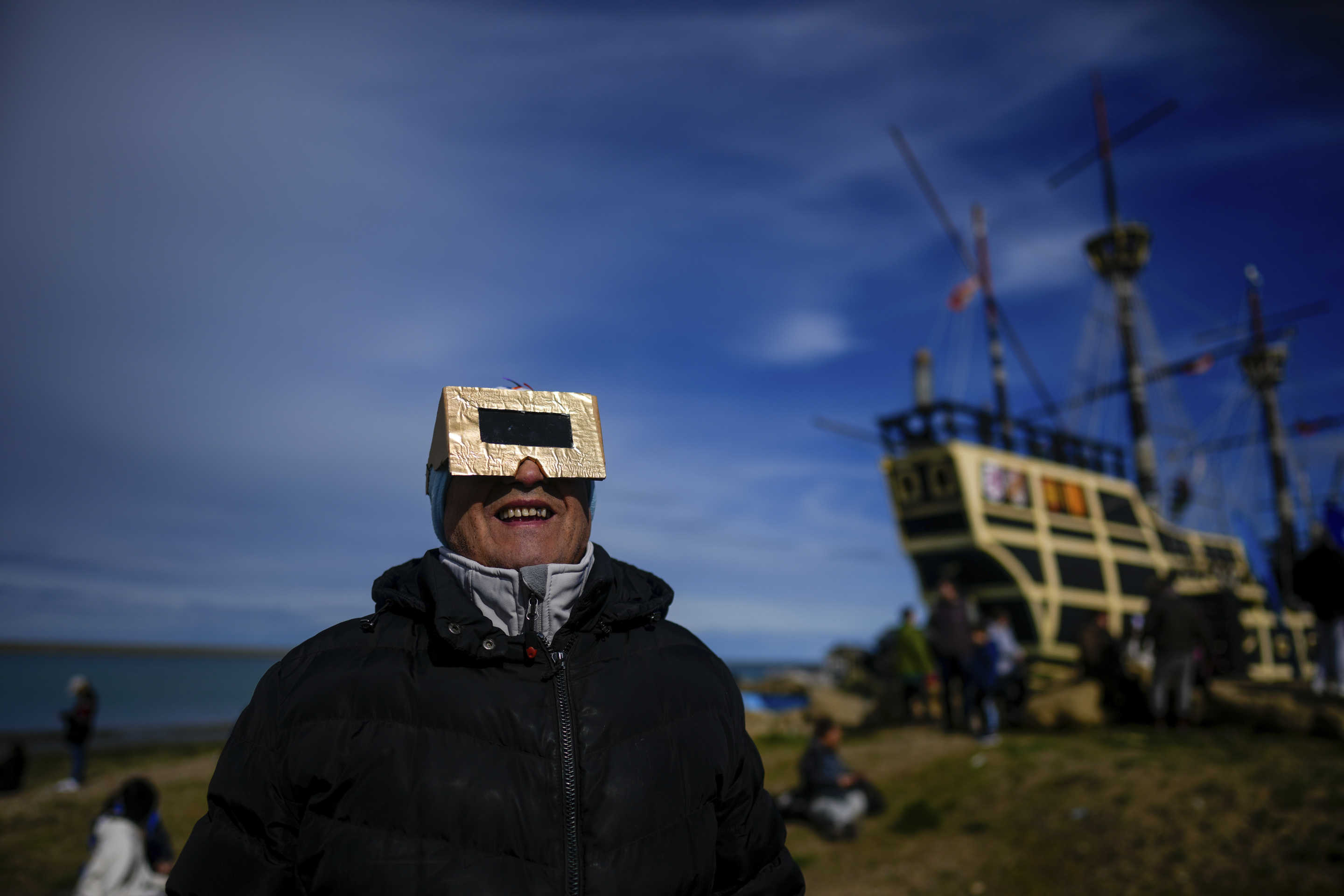 People watch an annular solar eclipse in Puerto San Julian, Argentina on Wednesday.