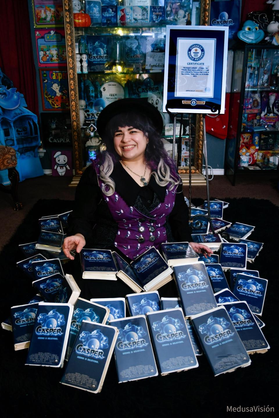 Irino poses in front of an array of CDs featuring Casper, with a packed cabinet behind her.