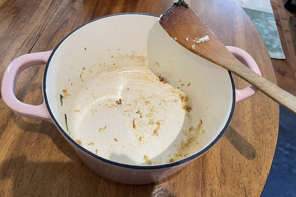 Dirty Crock-Pot Dutch Oven with wooden spatula on wooden table