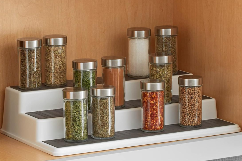 The spice rack holding assorted spices inside a cabinet