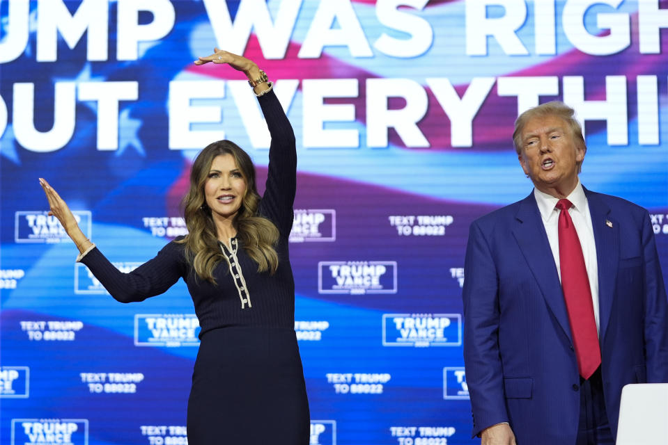 Republican presidential nominee former President Donald Trump watches as South Dakota Gov. Kristi Noem dances to the song 