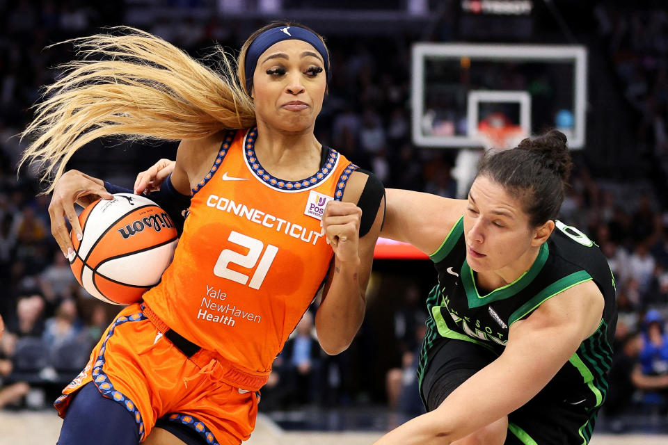 Oct 1, 2024; Minneapolis, Minnesota, USA; Connecticut Sun guard DiJonai Carrington (21) works around Minnesota Lynx forward Cecilia Zandalasini (9) during the second half of game two of the 2024 WNBA Semi-finals at Target Center. Mandatory Credit: Matt Krohn-Imagn Images     TPX IMAGES OF THE DAY