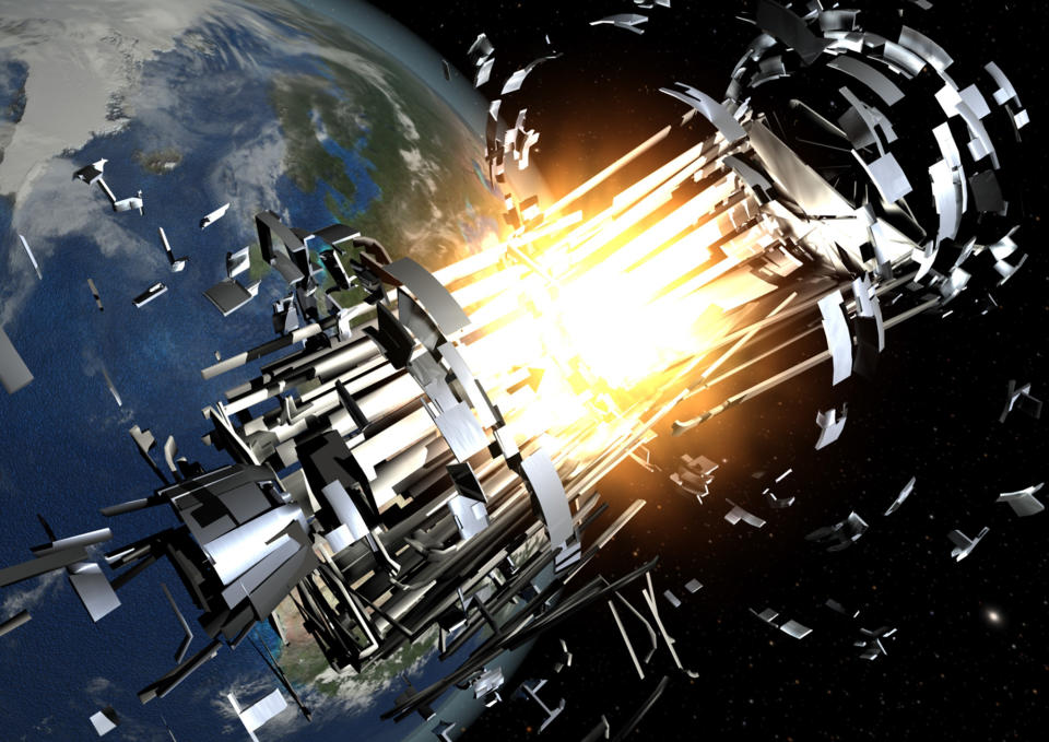  Illustration of a silver cylindrical object breaking apart in orbit, with earth in the background. 