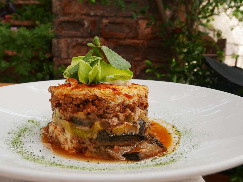 Moussaka for lunch with aubergine, tomato sauce and basil. Healthy eating with vegetable.