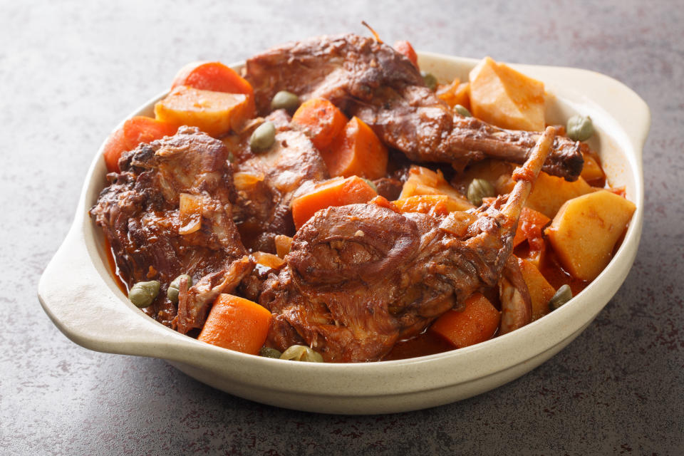 Rabbit Stew Maltese style or Stuffat tal-Fenek closeup in the pan on the table. Horizontal