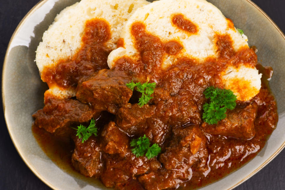 Beef goulash and dumplings (knedliky) on table