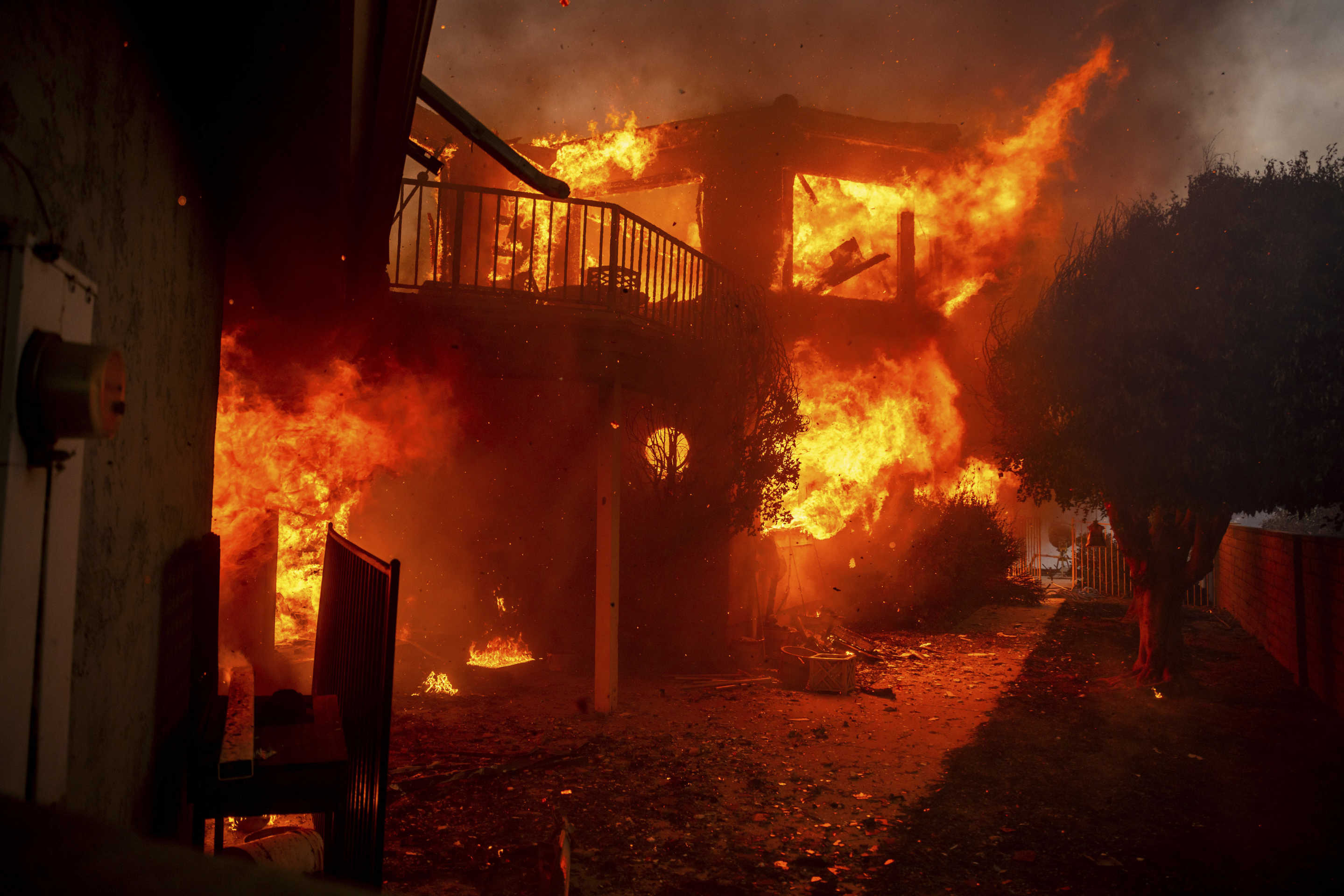 A two-story home engulfed in flames from the Mountain Fire on Wednesday. 