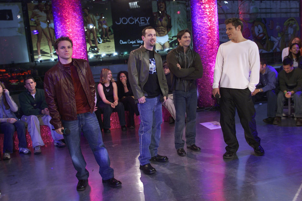 Nick Lachey, right, and 98 Degrees — Drew Lachey,  Justin Jeffre and Jeff Timmons — on the set of MTV's 