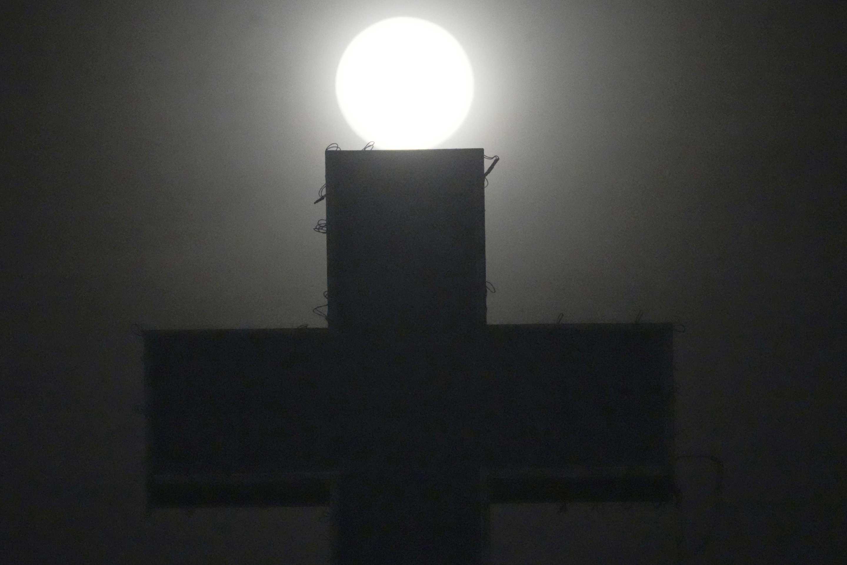 The last supermoon of the year, called the beaver moon, lights above a medical sign outside Phnom Penh Cambodia, on Friday. 