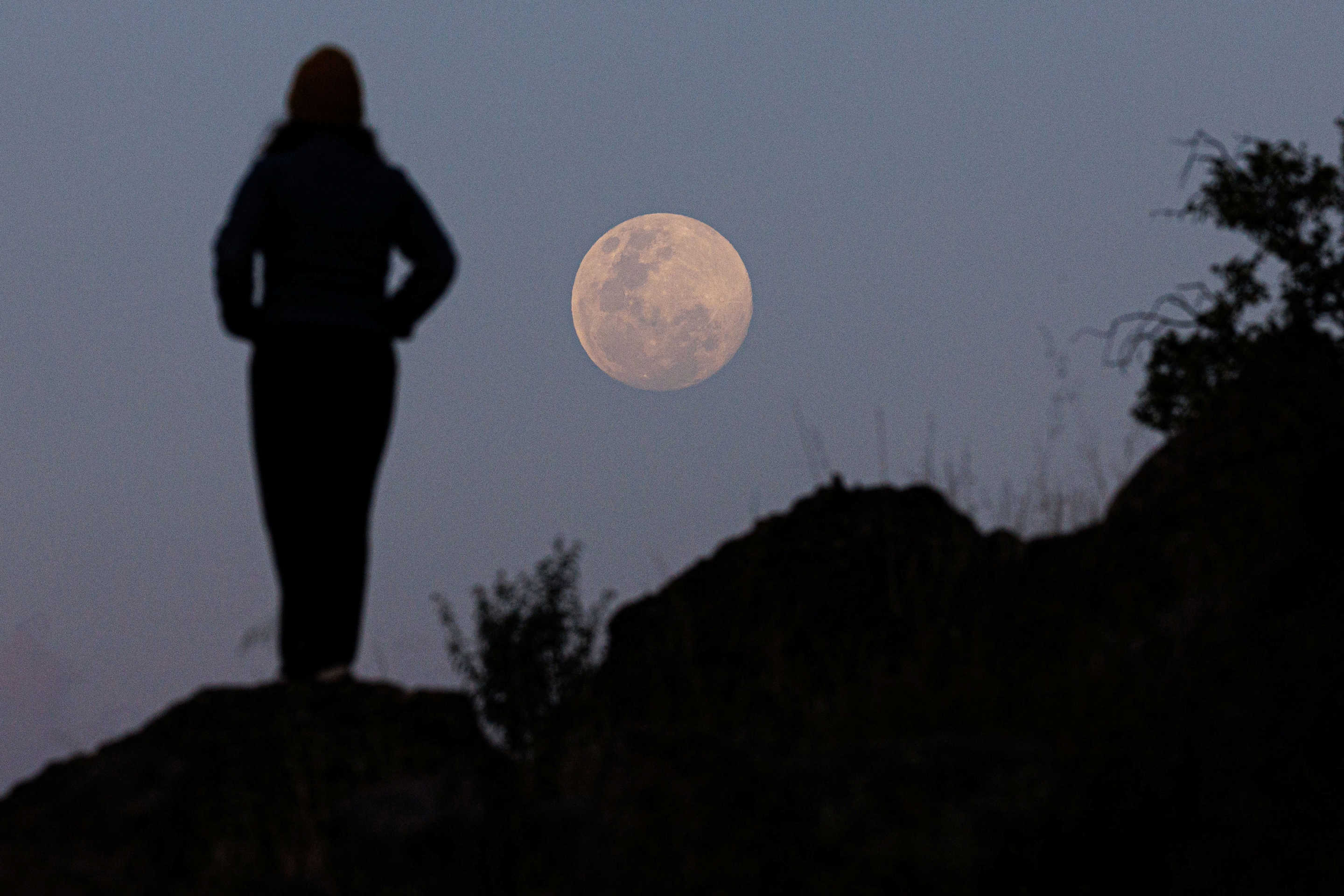 The moon rises over the Andes mountain range, in Santiago, Chile, on Thursday.