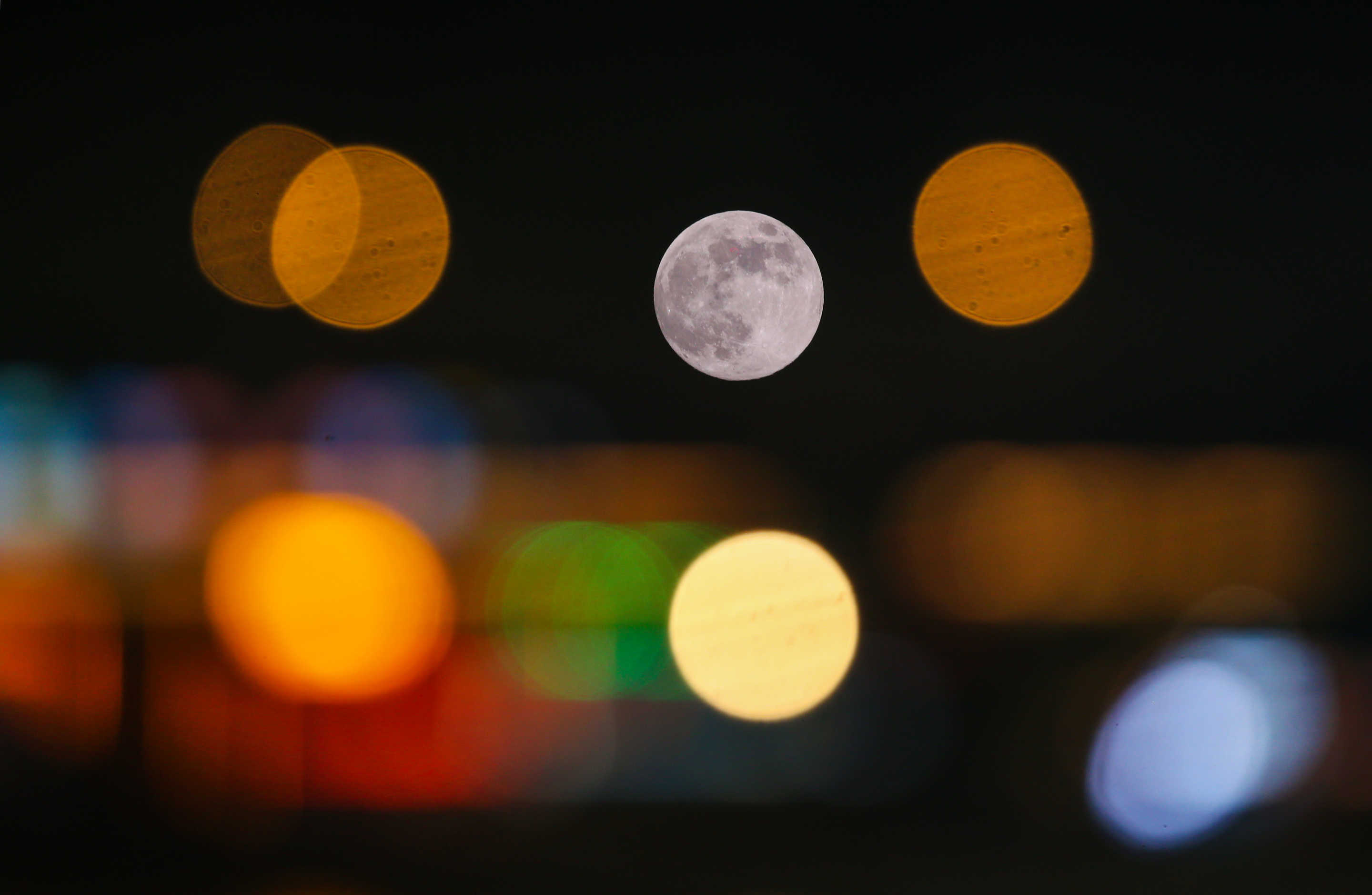 The supermoon is seen above a park in Lianyungang city, China, on Friday.