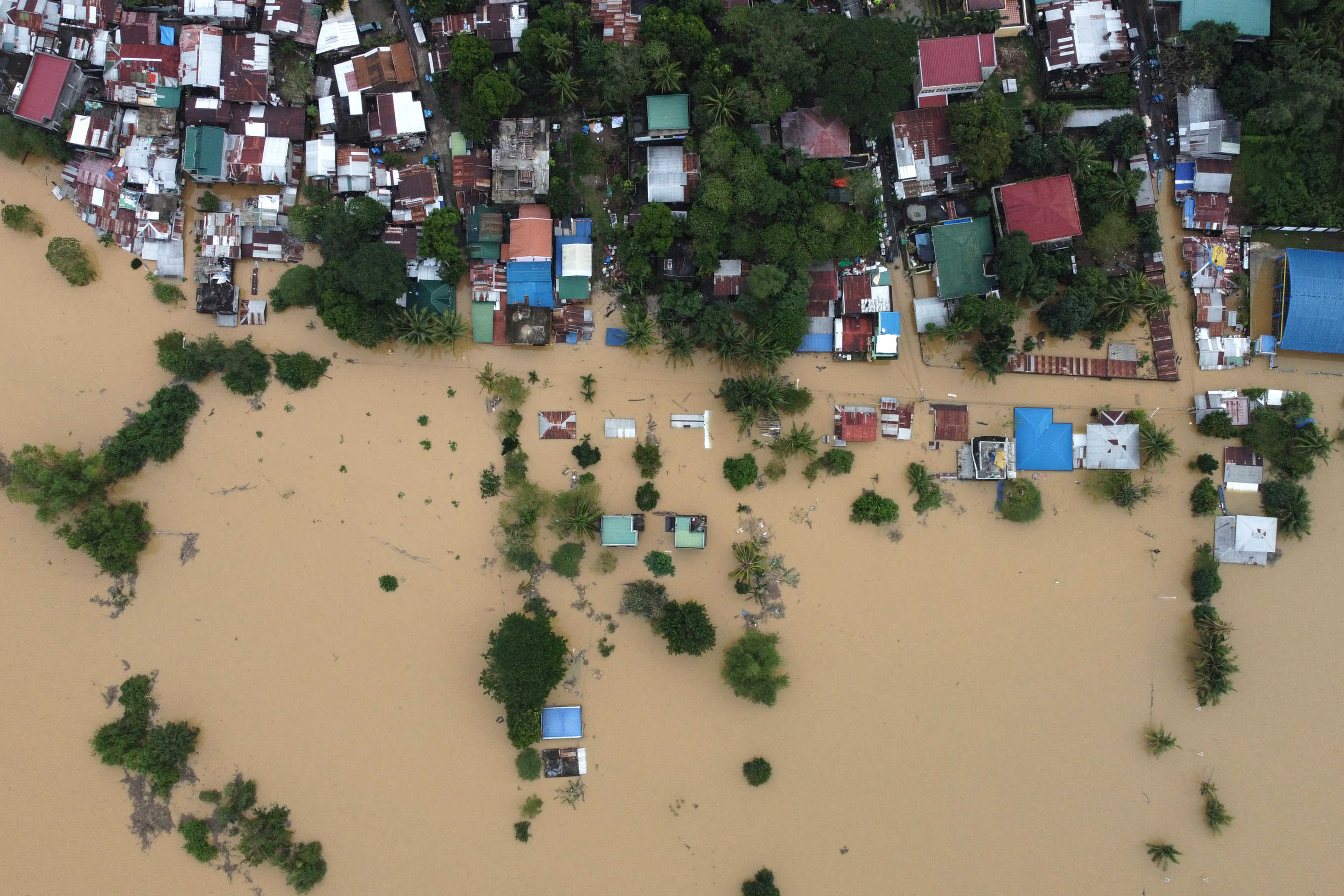 An aerial view shows submerged homes at a village in Ilagan, Isabela province.