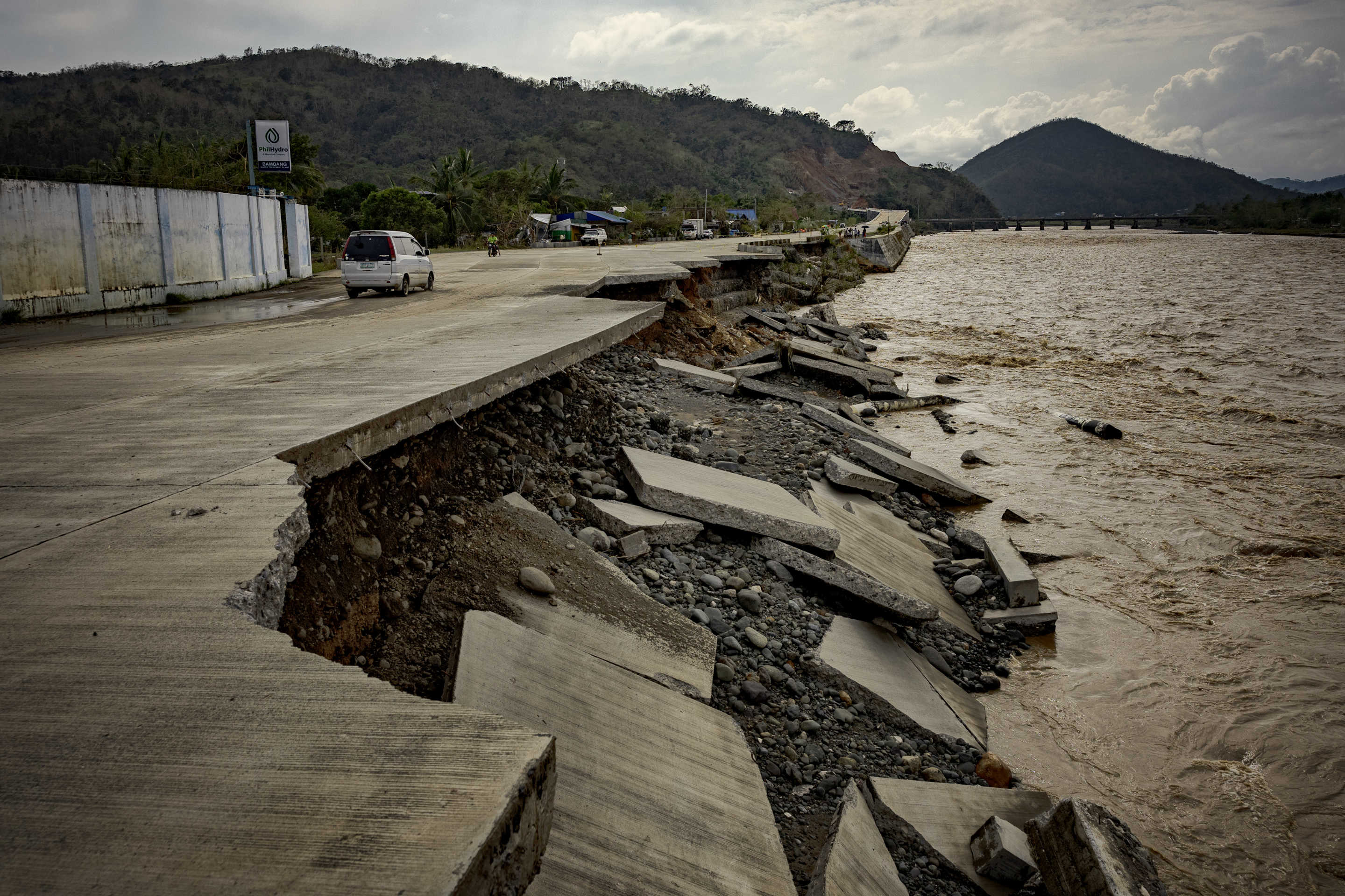 A partially collapsed road is seen after it was damaged by floods caused by Super Typhoon Man-yi in Bambang, Nueva Vizcaya province, Philippines.