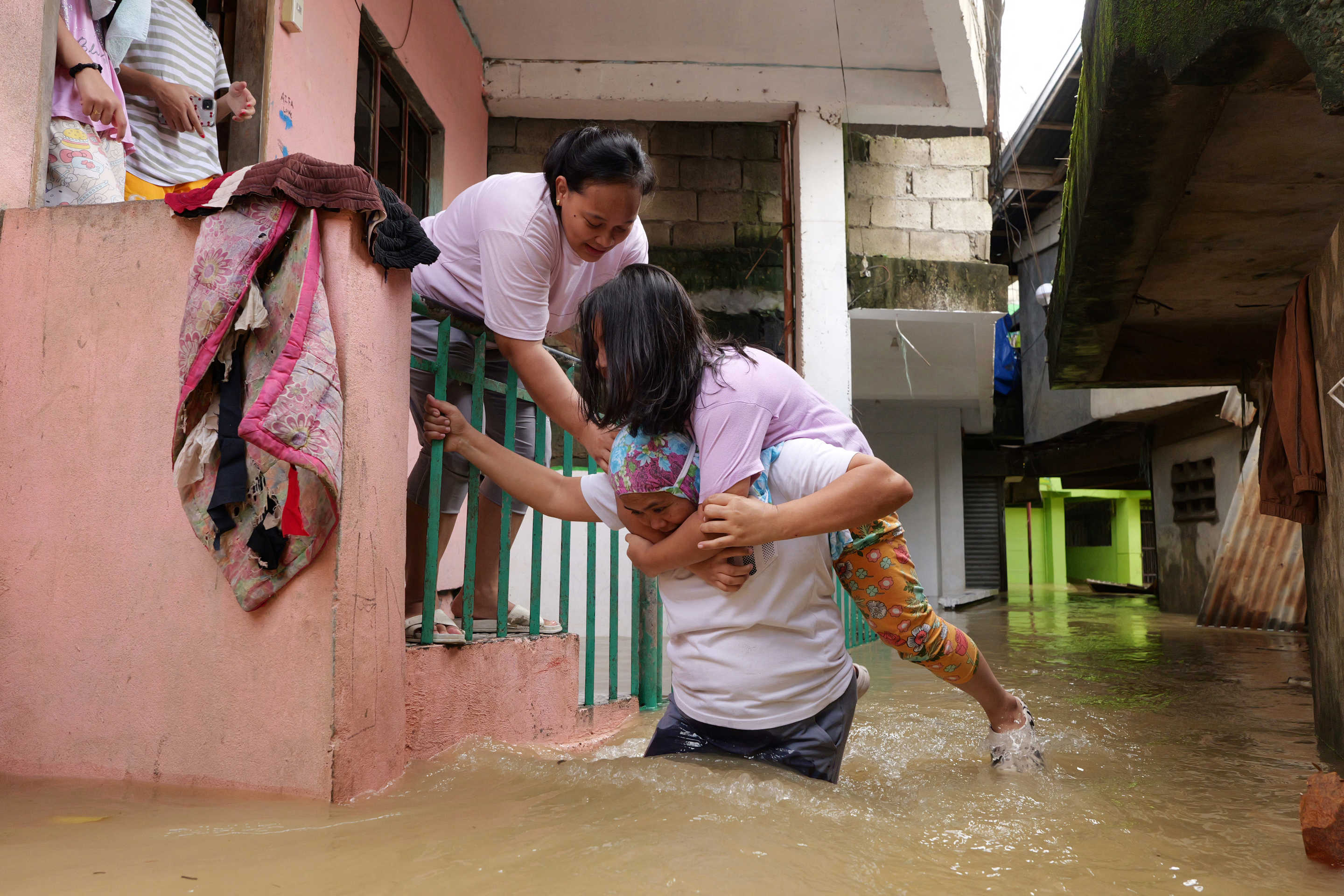 Residents evacuate from their flooded homes due to a swollen river caused by heavy rains and induced by Super Typhoon Man-yi in Tuguegarao City, Cagayan province.