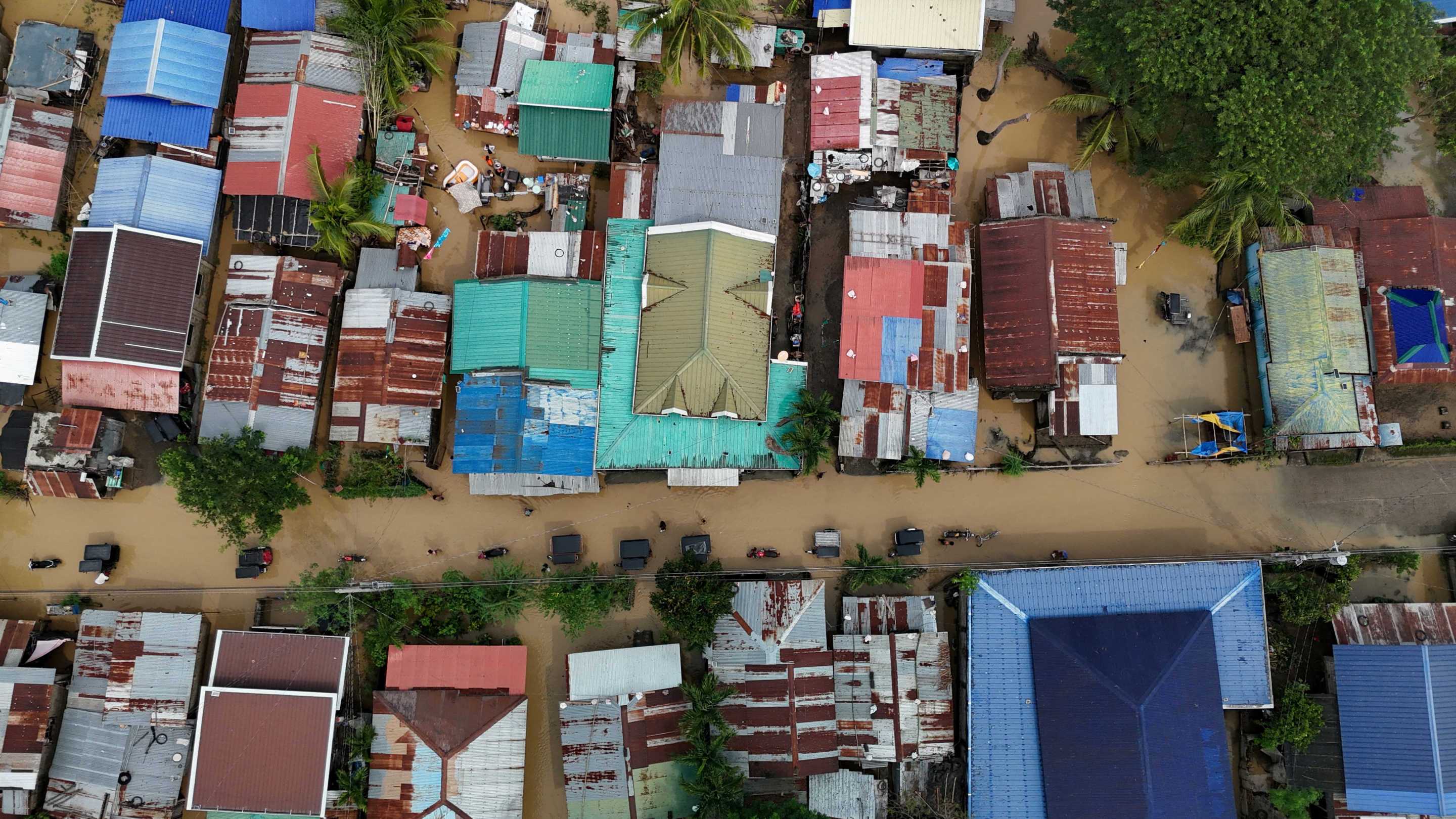 A drone view shows motorists on a flooded road following Super Typhoon Man-Yi in Quezon, Nueva Ecija province.