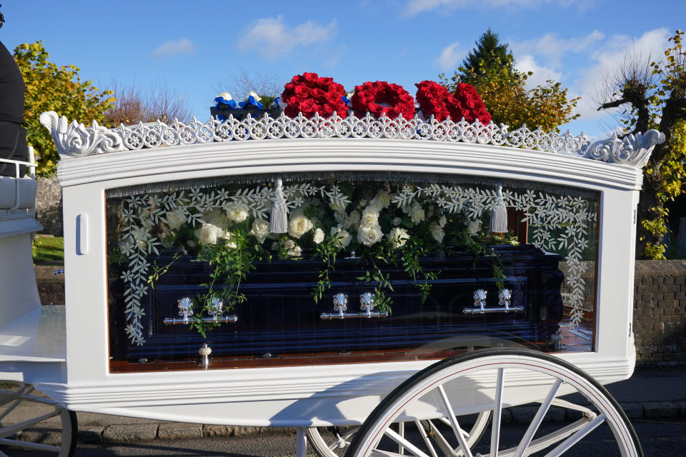 A horse-drawn carriage carrying the coffin of Liam Payne arrives for the funeral service.