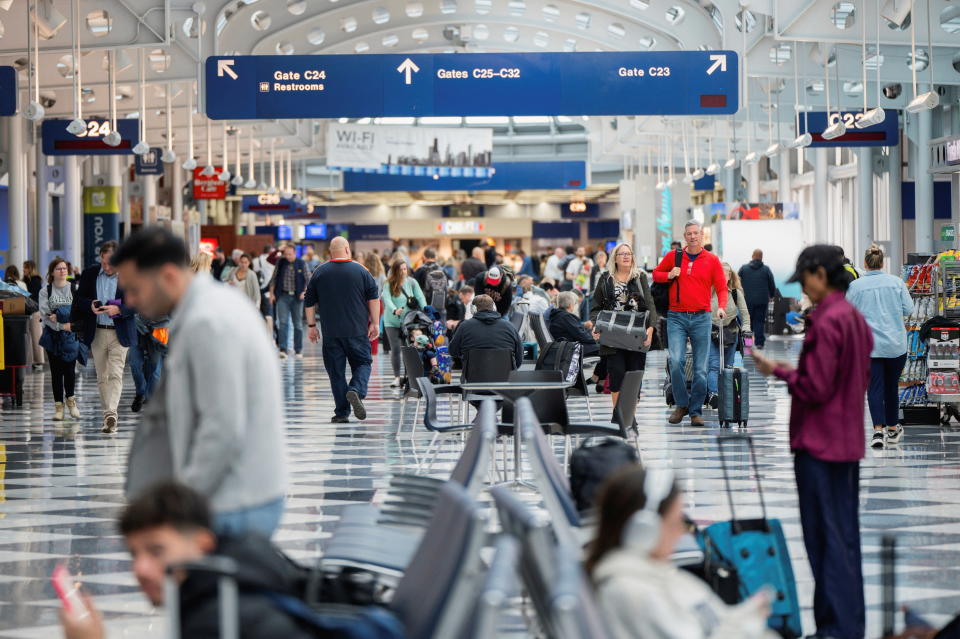 People walk through Chicago's O’Hare International Airport ahead of the Thanksgiving holiday on Nov. 22, 2023.