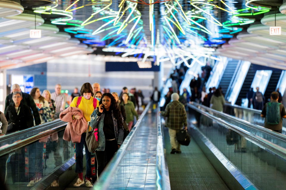 People walk to their gates at O’Hare International Airport in Chicago on Nov. 22, 2023.