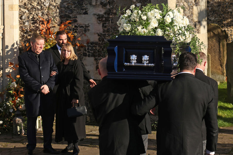 The parents of Liam Payne, Karen and Geoff Payne, watch as his coffin is carried into the funeral, on Thursday in Amersham, United Kingdom.