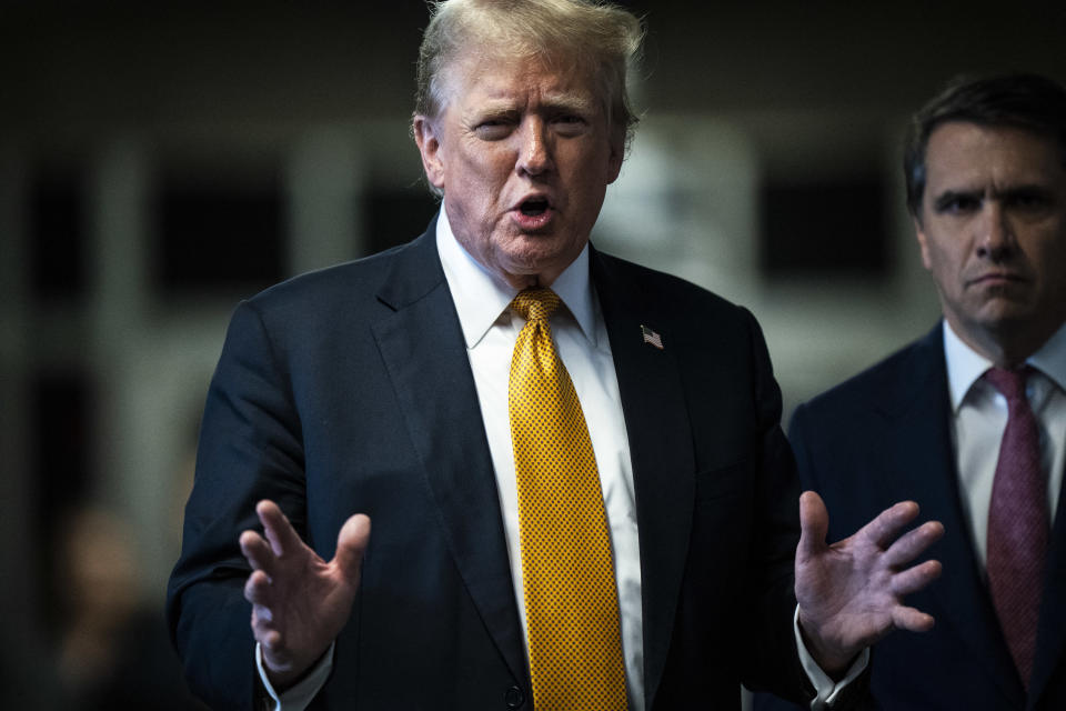 Trump addresses reporters, as Todd Blanche listens.