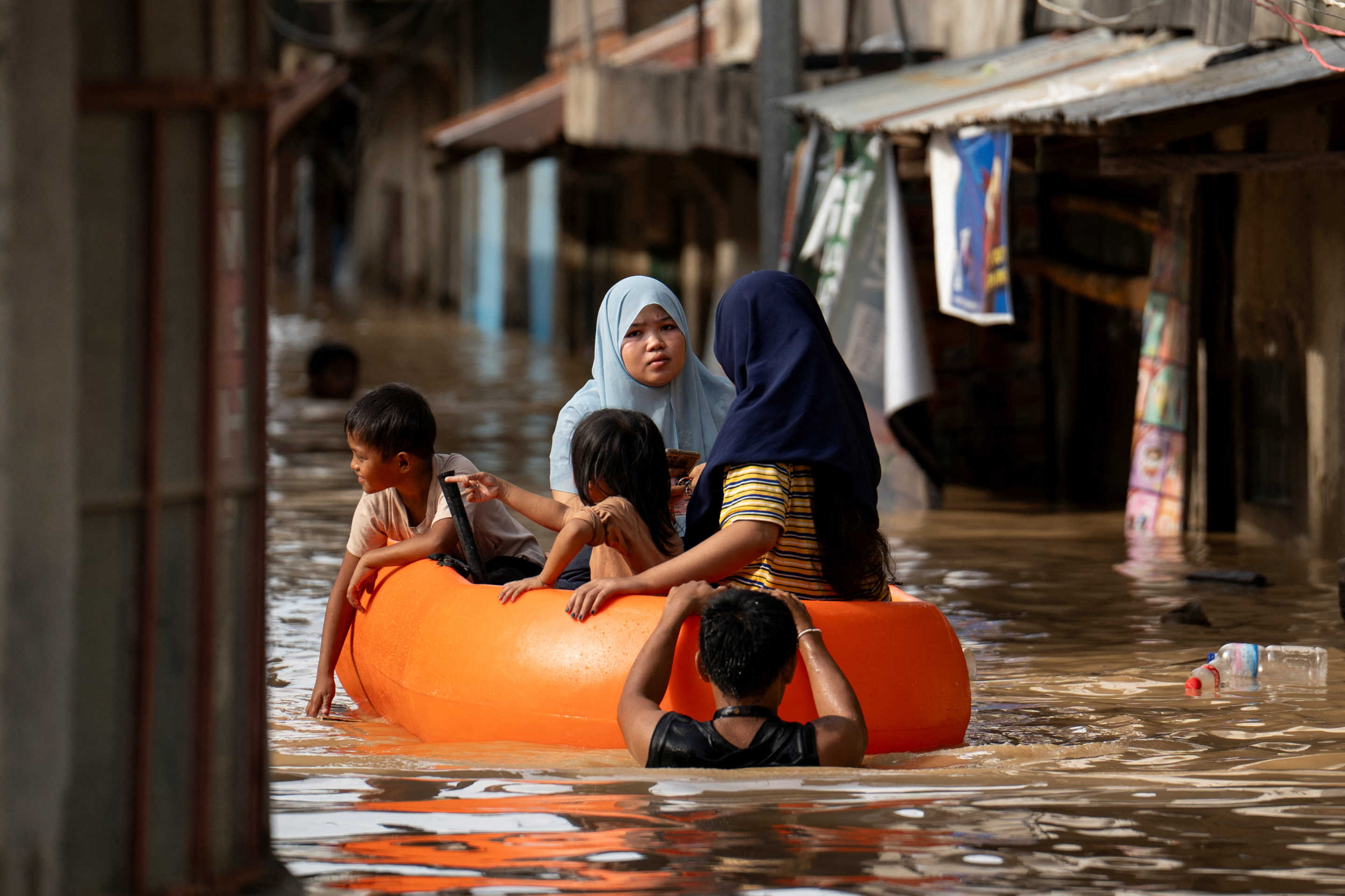 People ride on a rescue boat along a flooded street following Super Typhoon Man-Yi, in Cabanatuan, Nueva Ecija, Philippines.