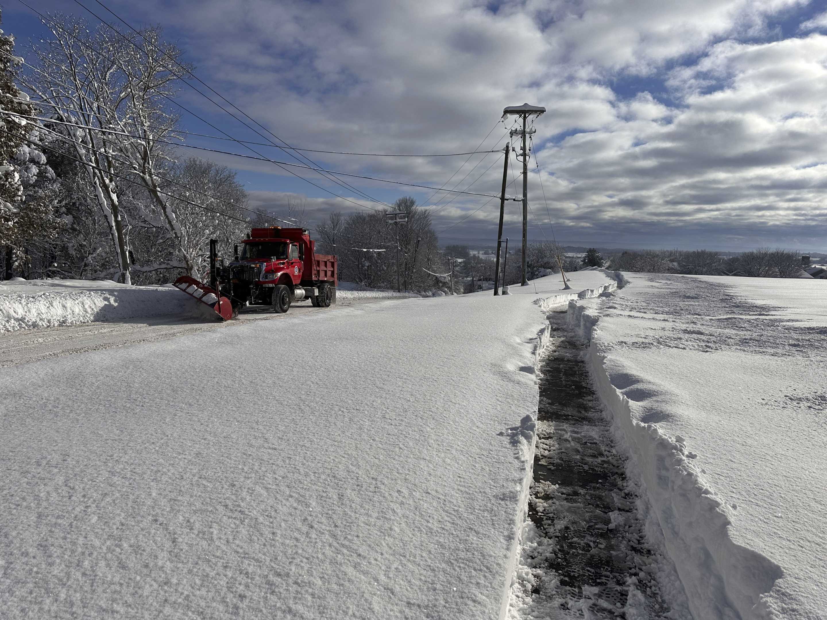 A snowplow clears an empty road in Lowville, N.Y.