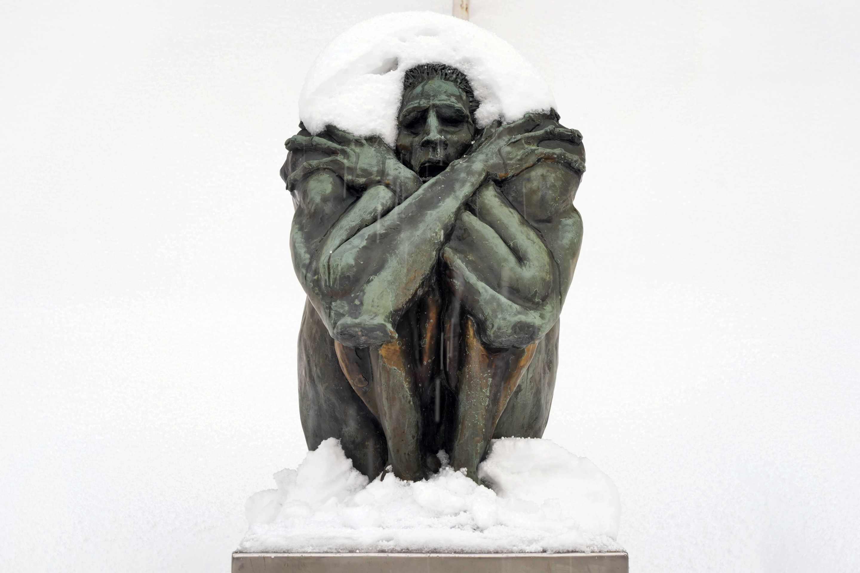 A statue is covered in snow in Erie, Pa.