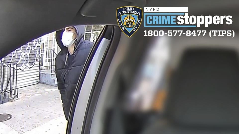 This undated photo released by the New York Police Department shows a suspect in the fatal shooting of UnitedHealthcare CEO Brian Thompson on Dec. 4, 2024, outside of a taxi. Part of the image was blurred by the source. (NYPD via AP)