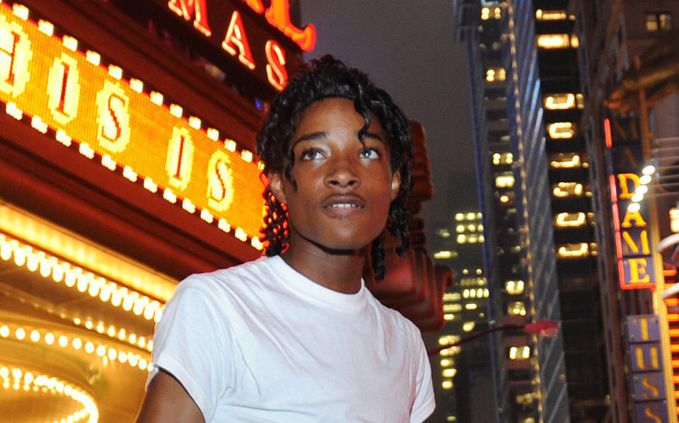 Jordan Neely standing by a theater marquee.