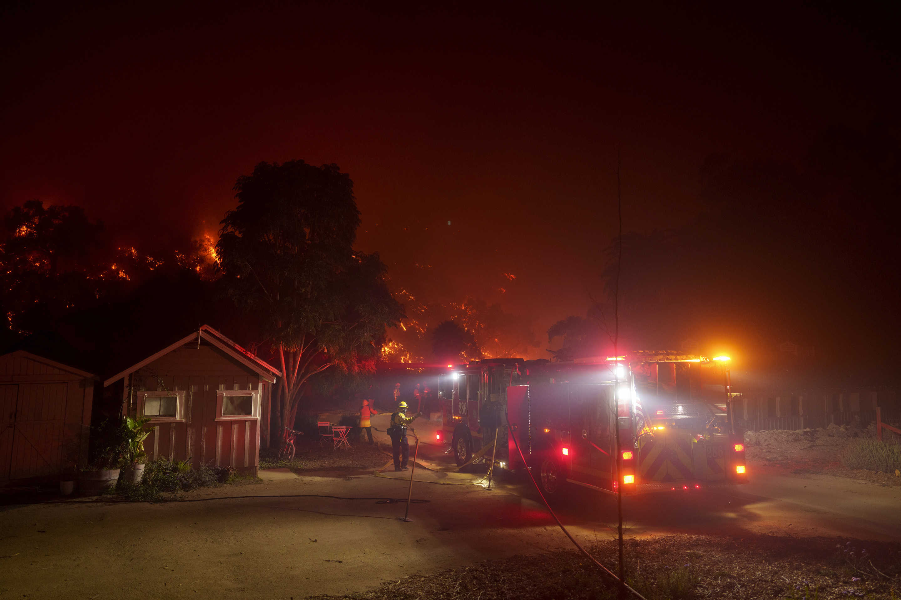 Fire engines lined up to protect a structure.