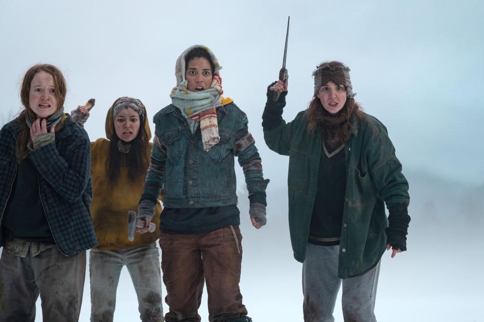 Liv Hewson, Alexa Barajas, Jasmin Savoy Brown and Sophie Nelisse, in winter clothes, line up, with Nelisse holding a large knife aloft.