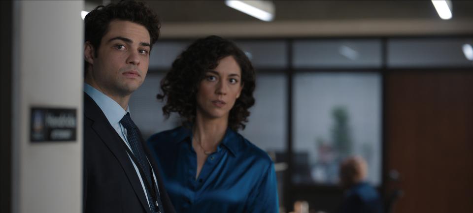 Noah Centineo and Kaylah Zander look apprehensive in what appears to be an office.